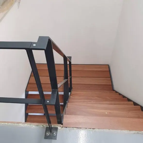 Houten trap met metalen leuning